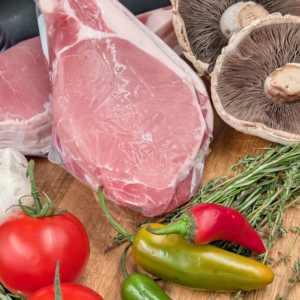 Unsmoked back bacon with a selection of herbs and vegetables