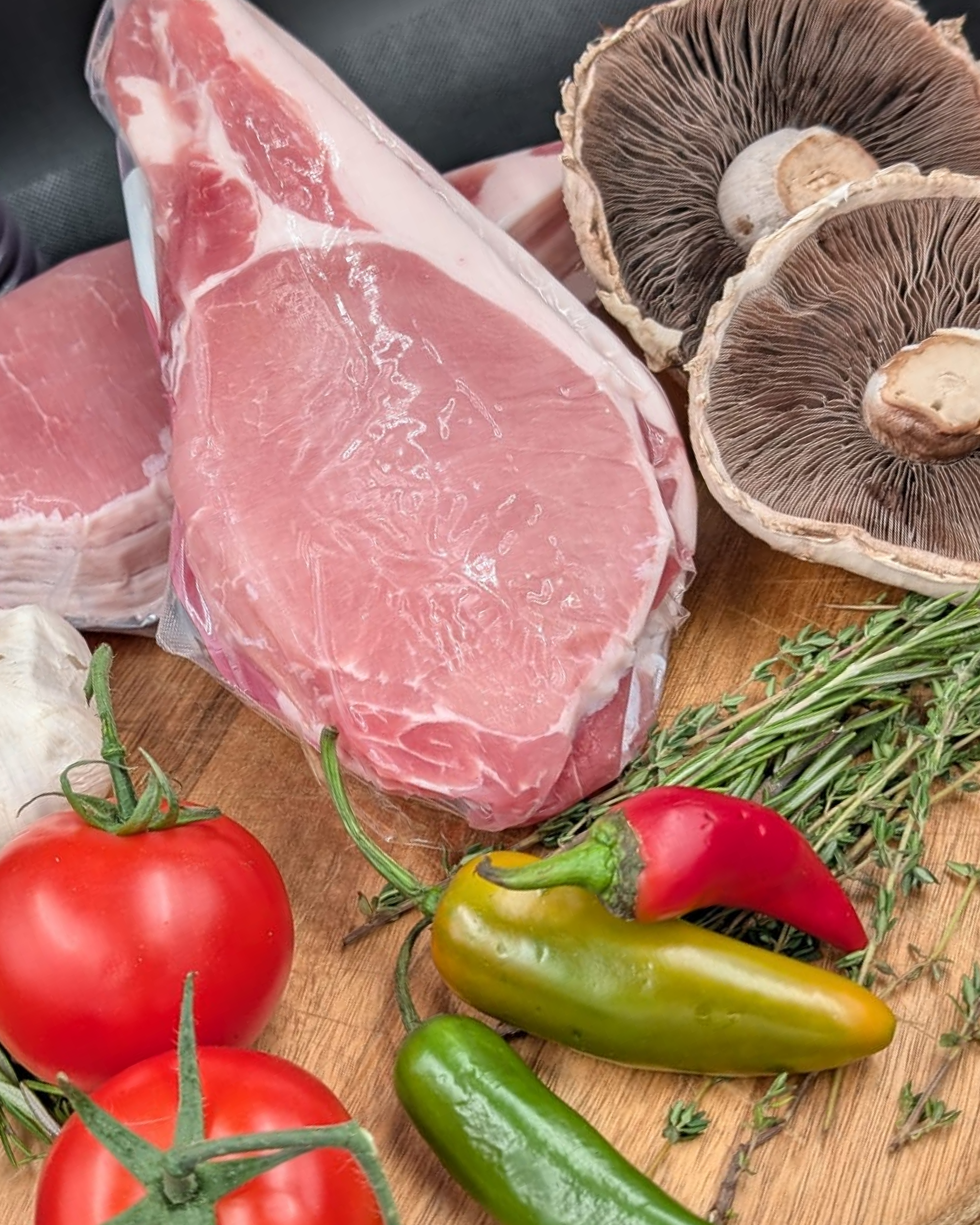 Unsmoked back bacon with a selection of herbs and vegetables