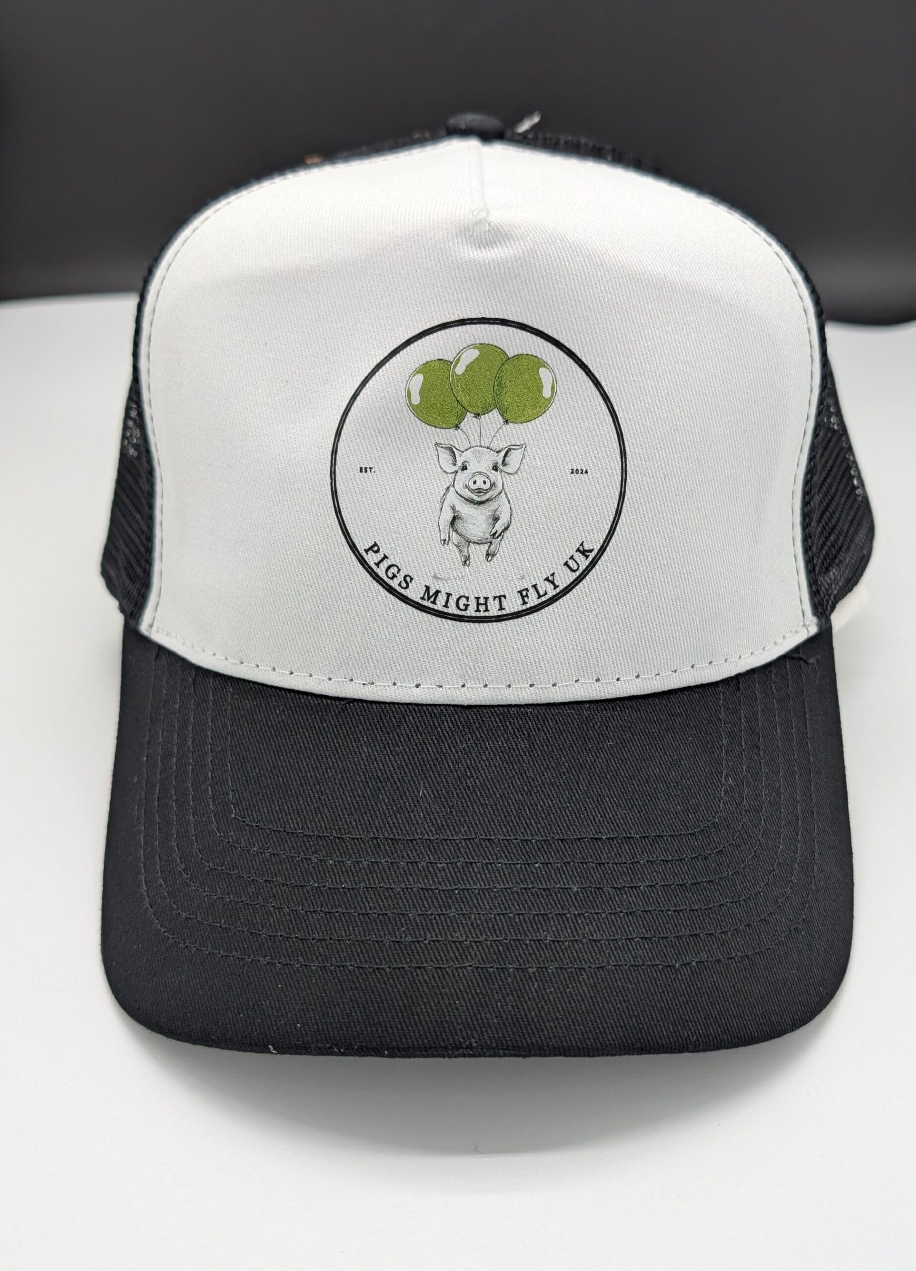 Pigs Might Fly UK black and white trucker cap front view